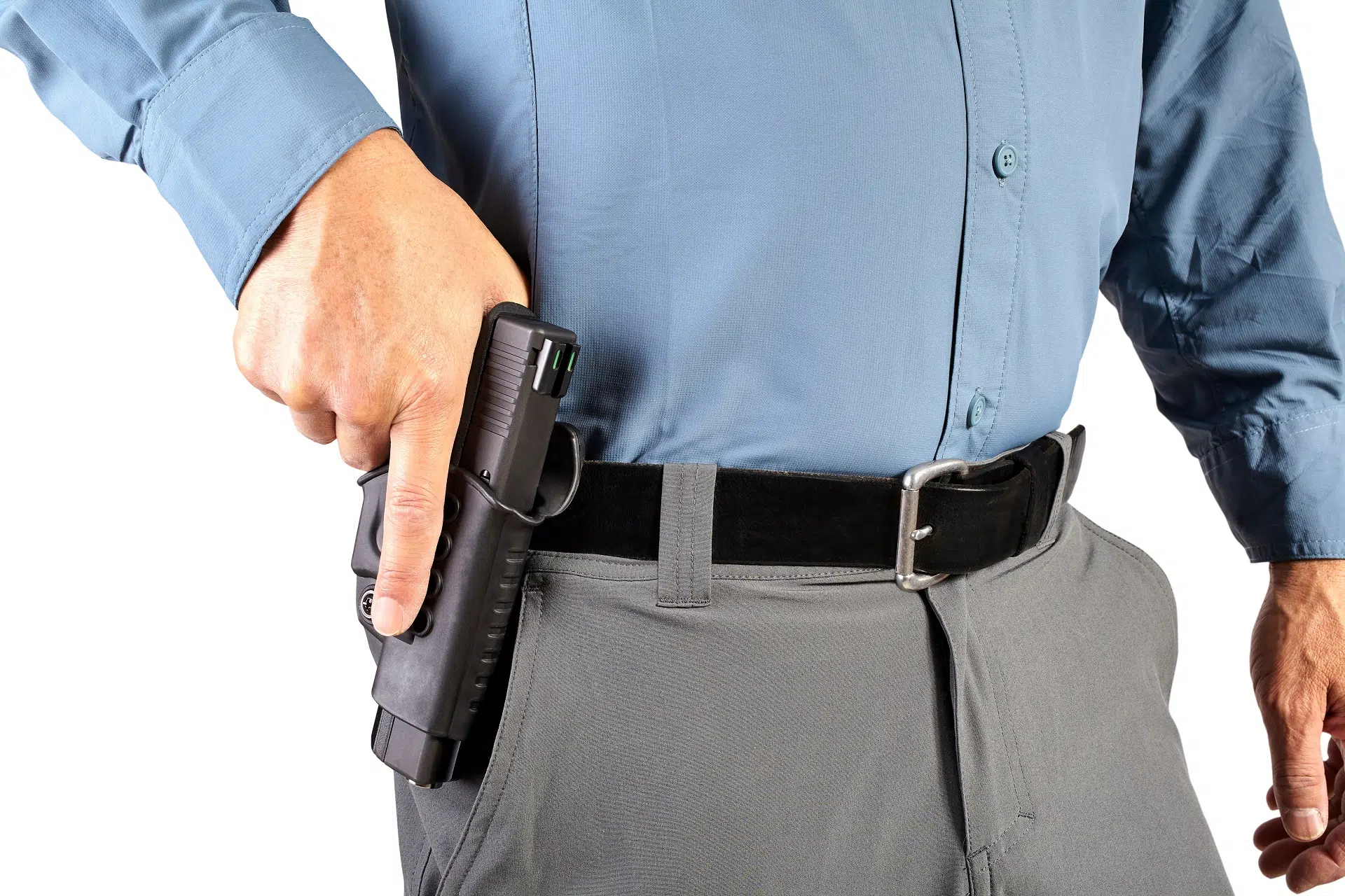 Man reaching for a pistol from his waistband holster