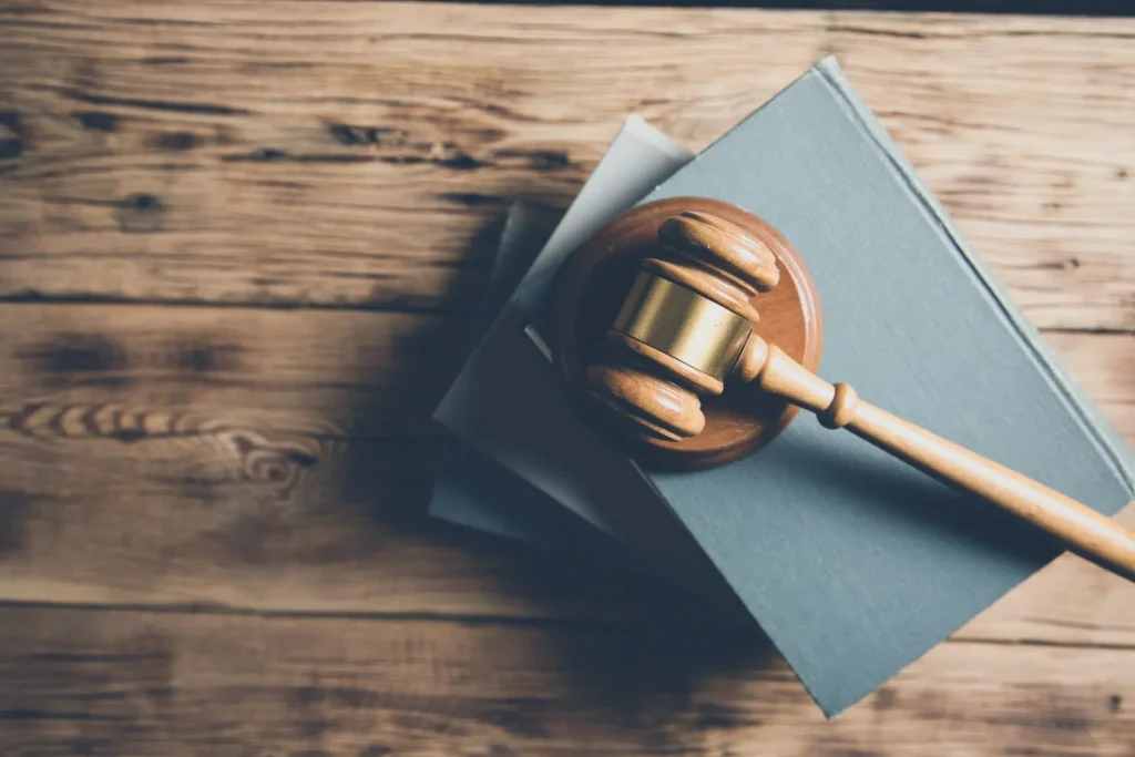 Wooden gavel resting on legal books