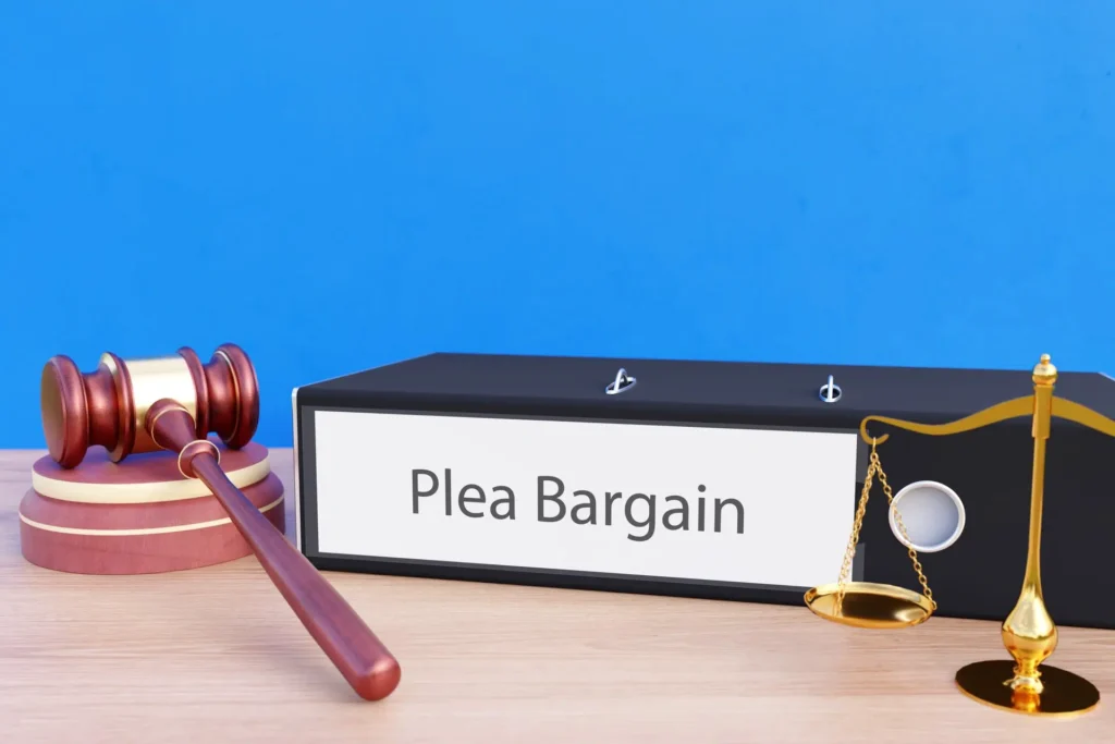 Gavel and scales next to a plea bargain folder