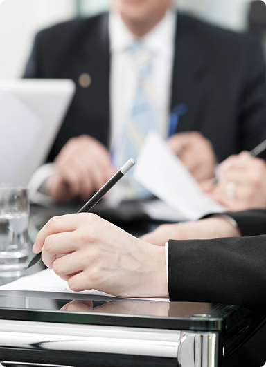 businesspeople at a meeting, likely in the process of signing a contract or important documents businesspeople at a meeting, likely in the process of signing a contract or important documents.