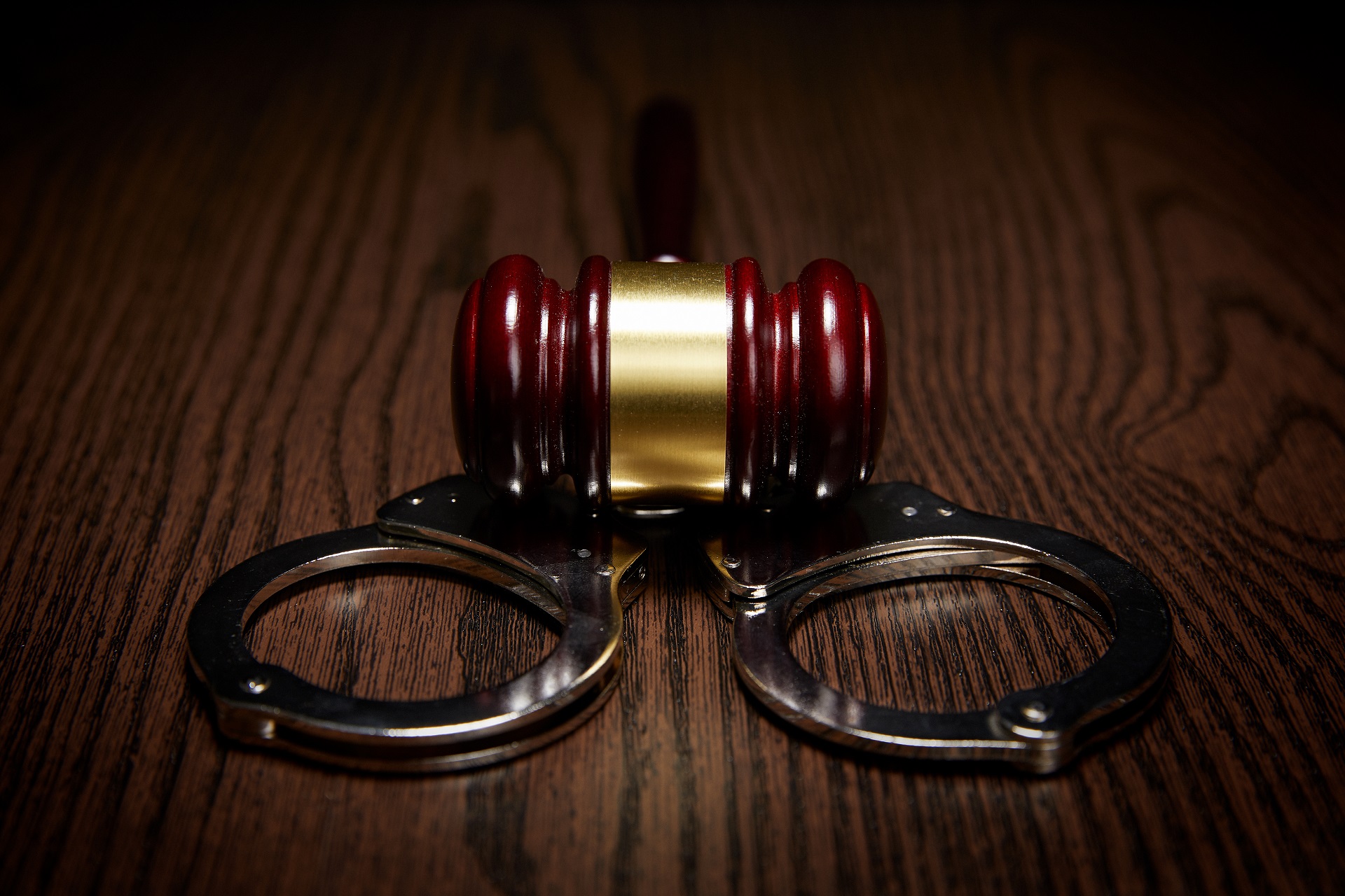 Close-up of Handcuffs, Judge Gavel on Wood | Murder Defense Lawyers in LA​​ | Wegman & Levin