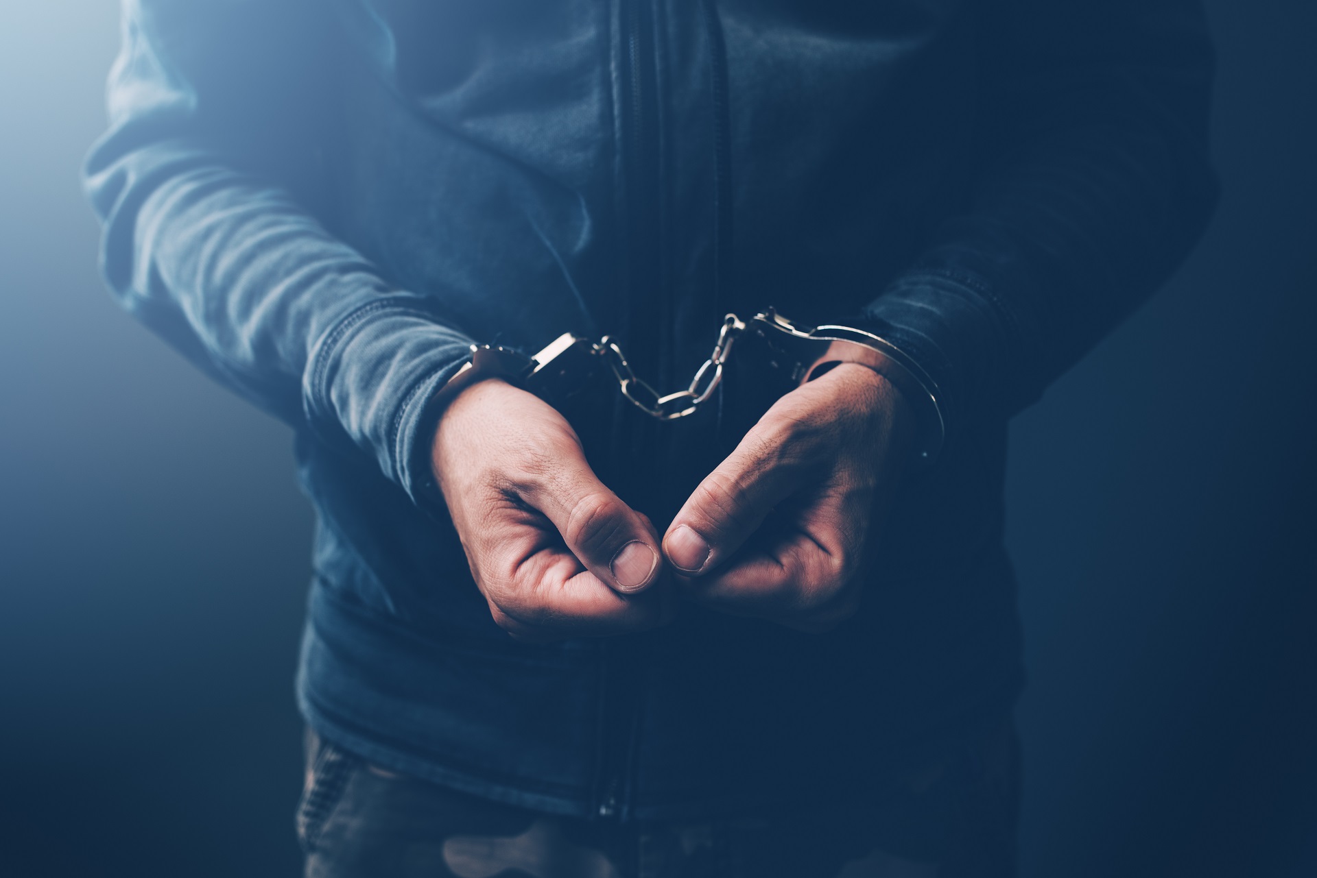 Arrested Man in Black Hoodie with Handcuffs | Los Angeles Theft Crimes Lawyer​​ | Wegman & Levin
