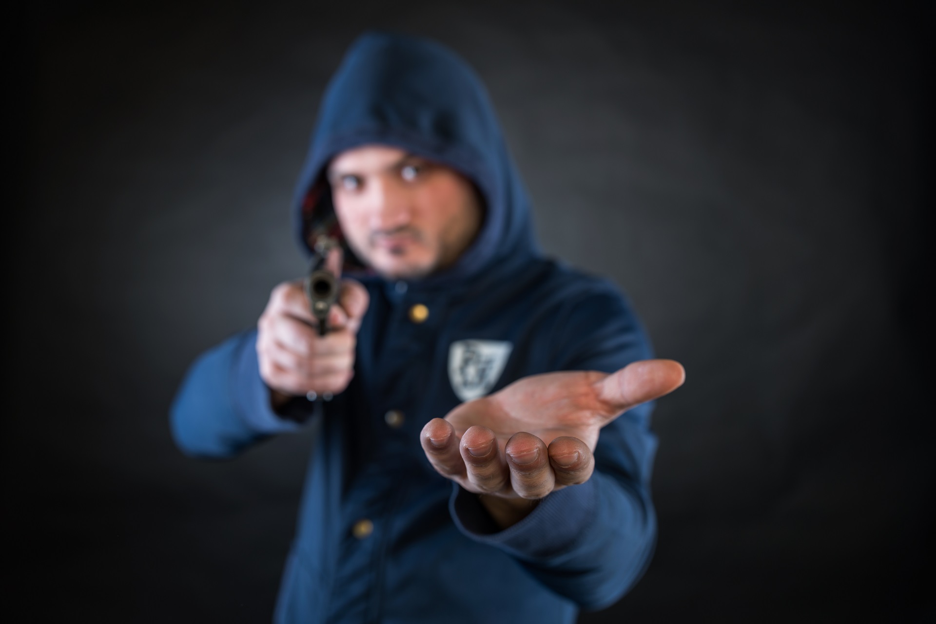 Man in A Hoodie Holding Up A Gun for Money | Los Angeles Theft Crimes Lawyer​​ | Wegman & Levin