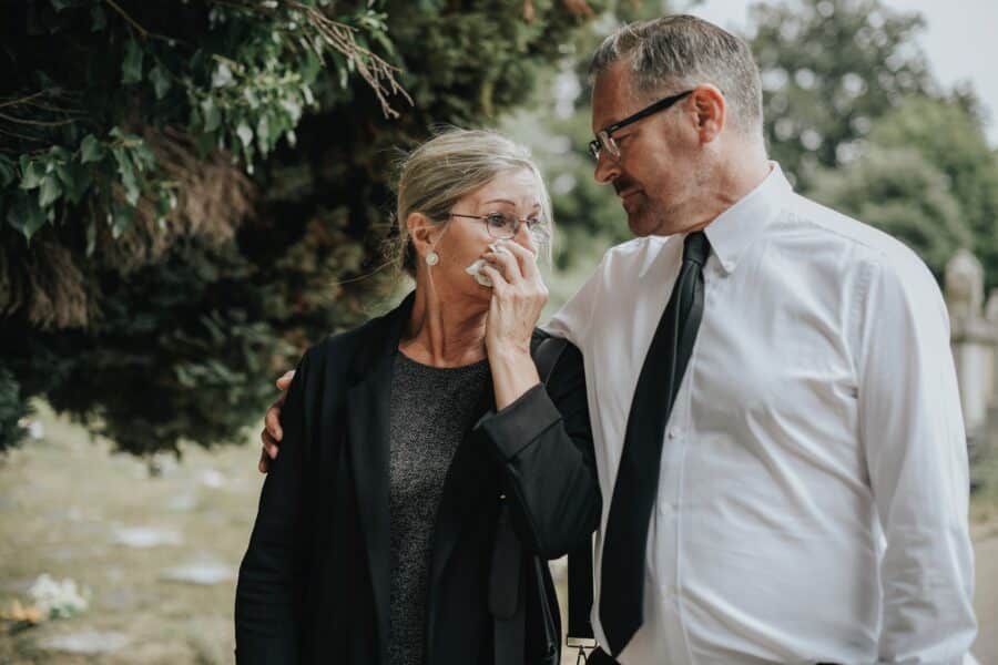 Elderly couple standing together infront of tree | Domestic Violence Defense Lawyer | Wegman & Levin