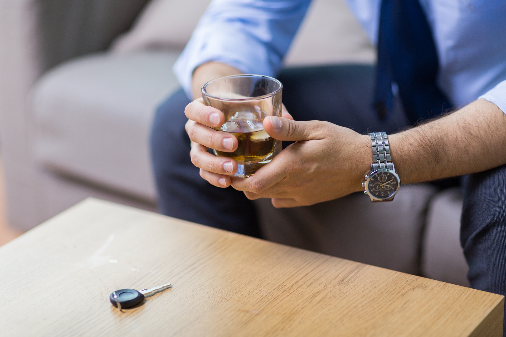 Male Hands with Whiskey Glass and Car Key on Table | Criminal Attorney in LA | Wegman & Levin