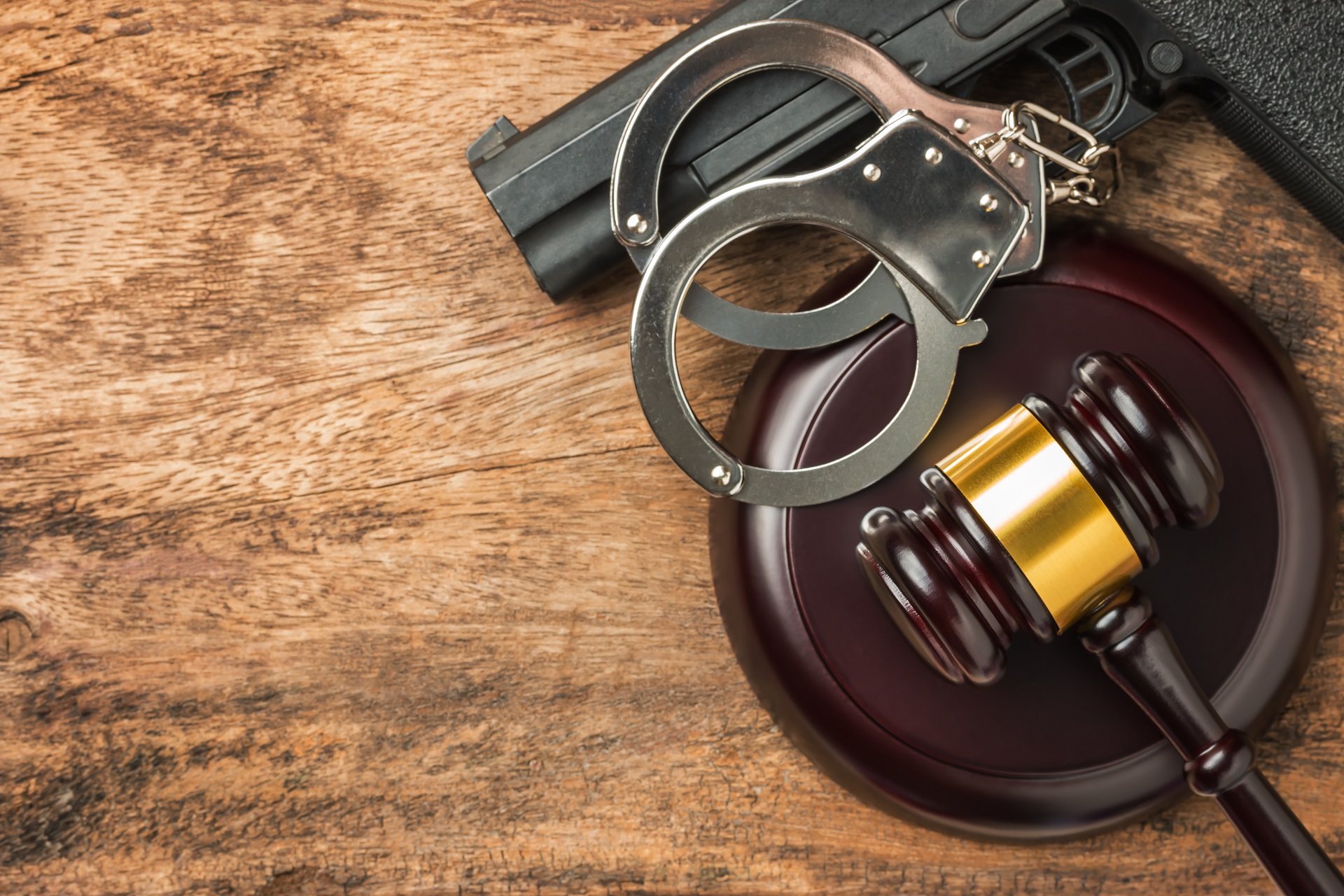 Top View of Gavel, Gun and Handcuffs | Criminal Attorney in LA California | Wegman & Levin