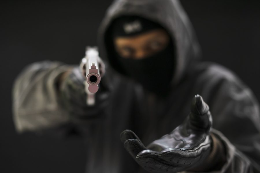 Robber In Black Pointing A Gun | Criminal Attorney in Los Angeles | Wegman & Levin